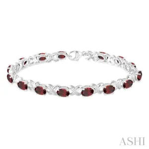 7x5  MM Oval Cut Garnet and 1/20 Ctw Round Cut Diamond Fashion Bracelet in Sterling Silver